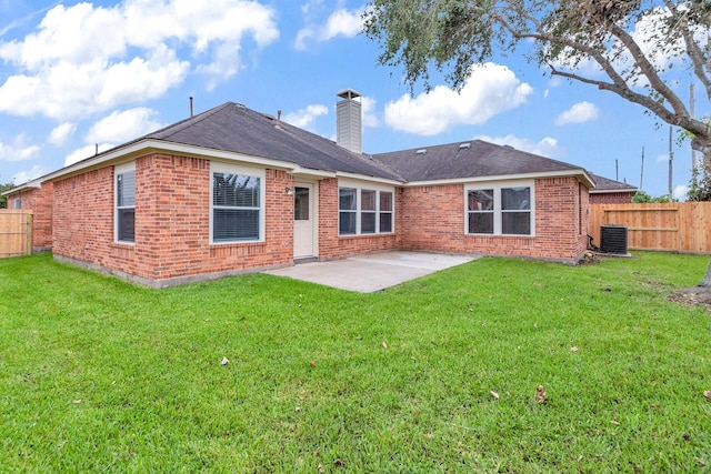 rear view of house with a lawn, central AC unit, and a patio