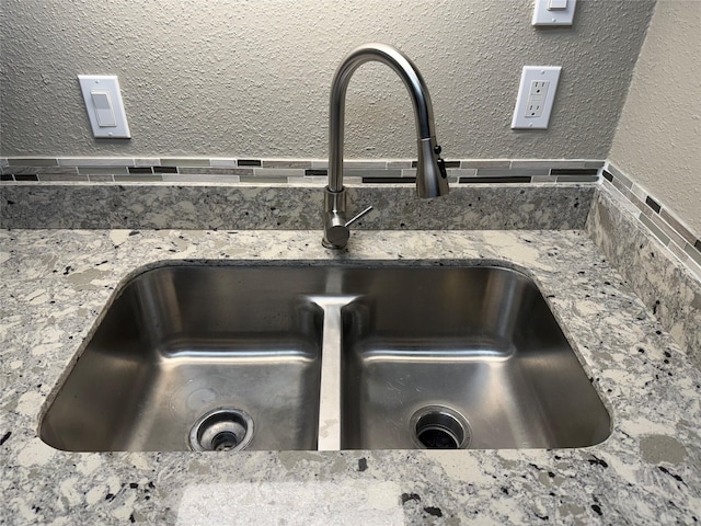 room details featuring stone counters and sink