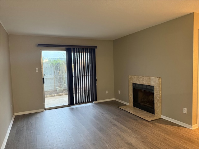 unfurnished living room with a premium fireplace and hardwood / wood-style flooring