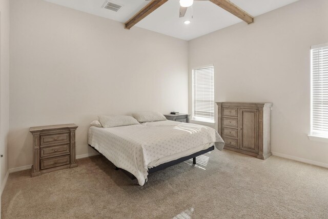 carpeted bedroom with ceiling fan and beam ceiling