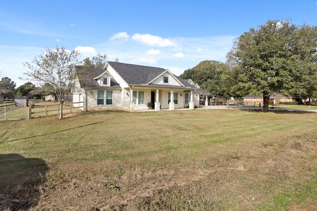 view of front of home with covered porch and a front lawn