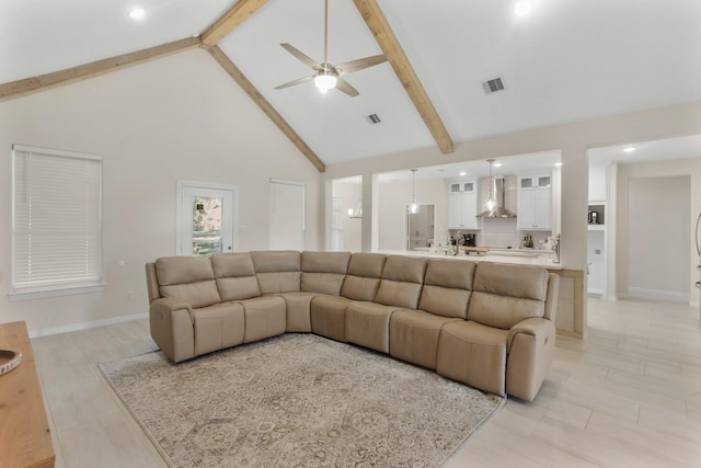 living room with beam ceiling, high vaulted ceiling, and ceiling fan