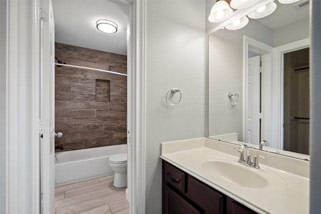 full bathroom featuring vanity, toilet, and tiled shower / bath combo