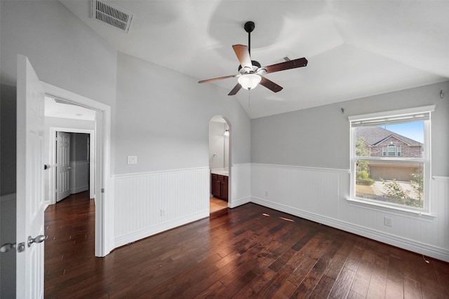 unfurnished room featuring dark hardwood / wood-style floors, ceiling fan, and vaulted ceiling