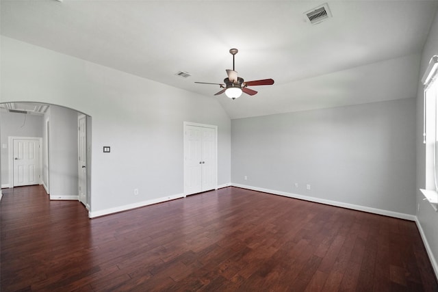 spare room with ceiling fan, lofted ceiling, and dark wood-type flooring