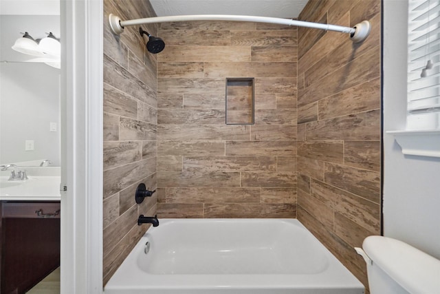 full bathroom featuring vanity, tiled shower / bath combo, and toilet