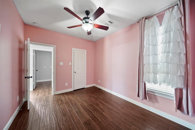 unfurnished bedroom featuring ceiling fan and dark hardwood / wood-style flooring