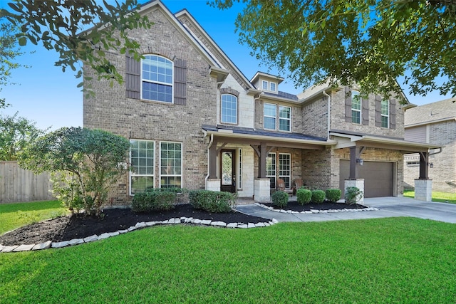 view of front of property featuring a front lawn, a porch, and a garage