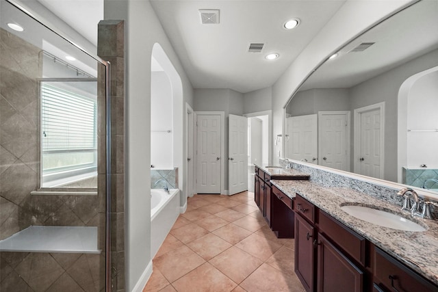 bathroom featuring tile patterned flooring, vanity, and independent shower and bath