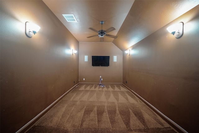 home theater room with ceiling fan, lofted ceiling, and light carpet