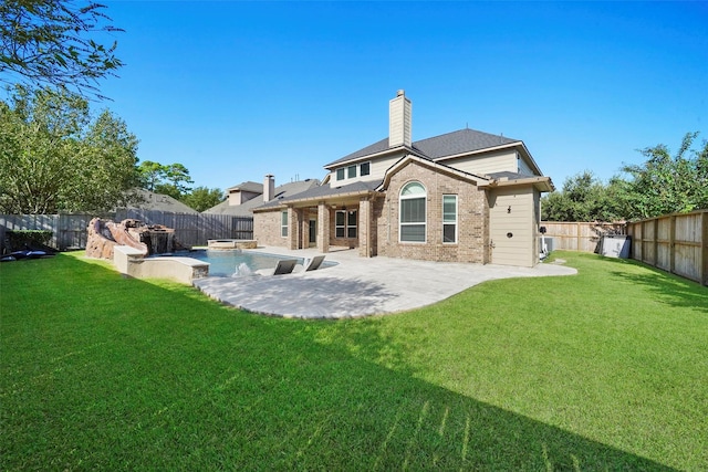 back of house featuring a yard and a patio