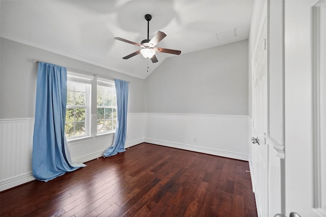 spare room featuring ceiling fan, dark wood-type flooring, and vaulted ceiling