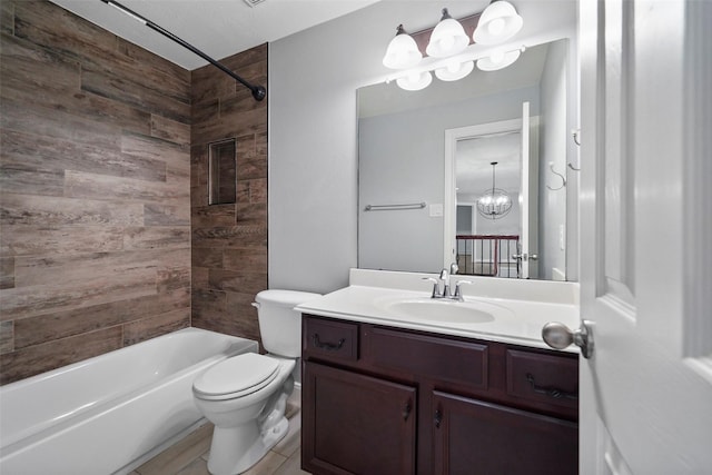 full bathroom with vanity, toilet, tiled shower / bath, and a notable chandelier