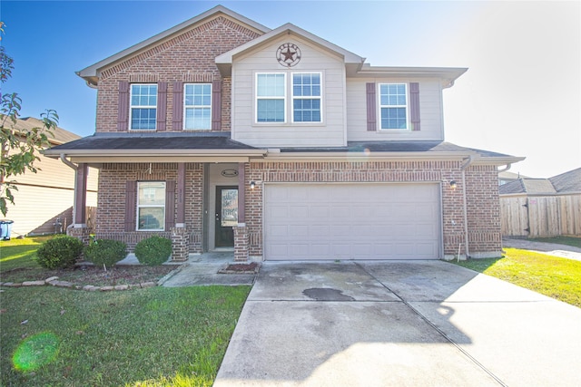 view of front of property with a front yard and a garage