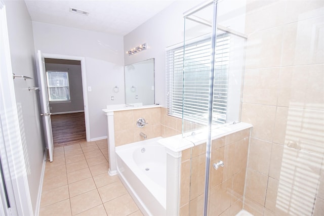 bathroom with tile patterned flooring and plus walk in shower