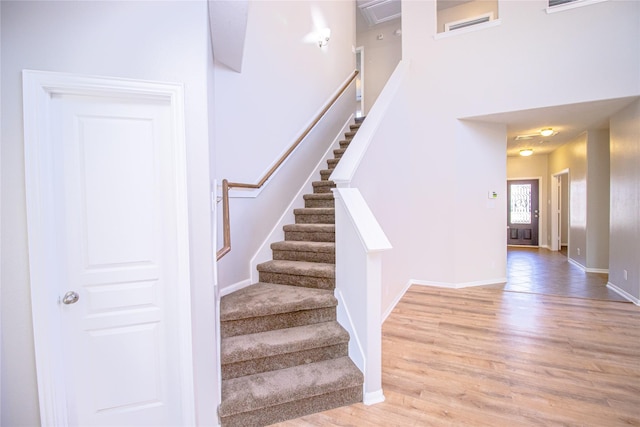 stairs featuring wood-type flooring