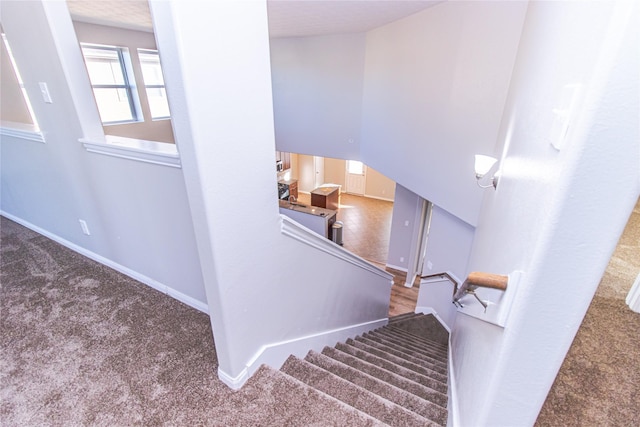 stairs with carpet and vaulted ceiling