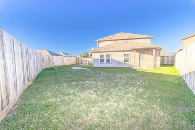 rear view of house with a yard