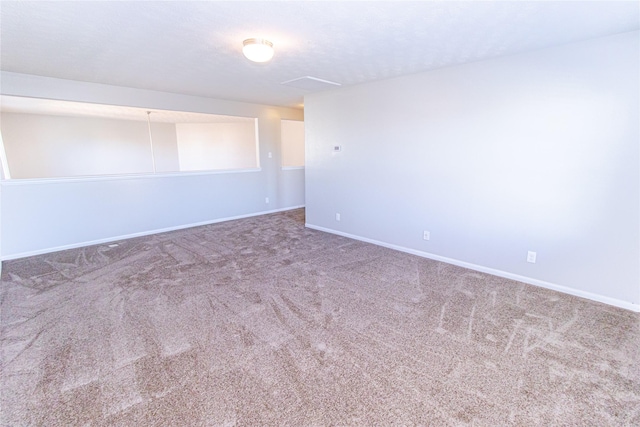 empty room with carpet floors and a textured ceiling