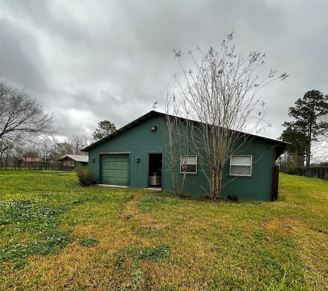 view of outdoor structure featuring a garage and driveway