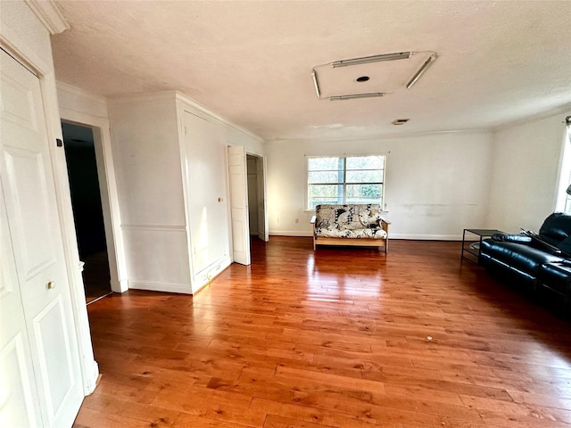 unfurnished living room featuring baseboards and light wood finished floors