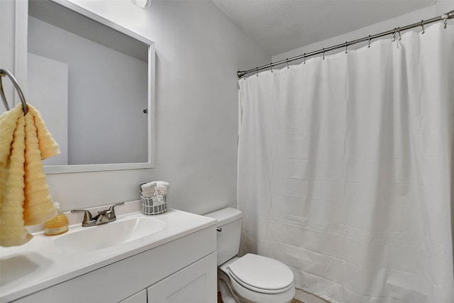 bathroom featuring vanity, curtained shower, toilet, and a textured ceiling