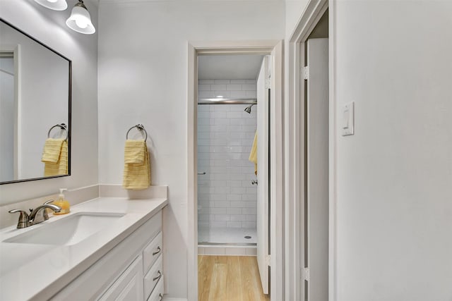 bathroom with vanity, hardwood / wood-style flooring, and an enclosed shower