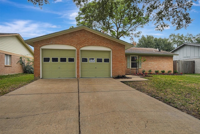 ranch-style home with a front yard and a garage