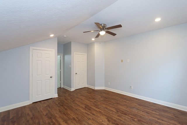 bonus room with ceiling fan, dark hardwood / wood-style flooring, lofted ceiling, and a textured ceiling