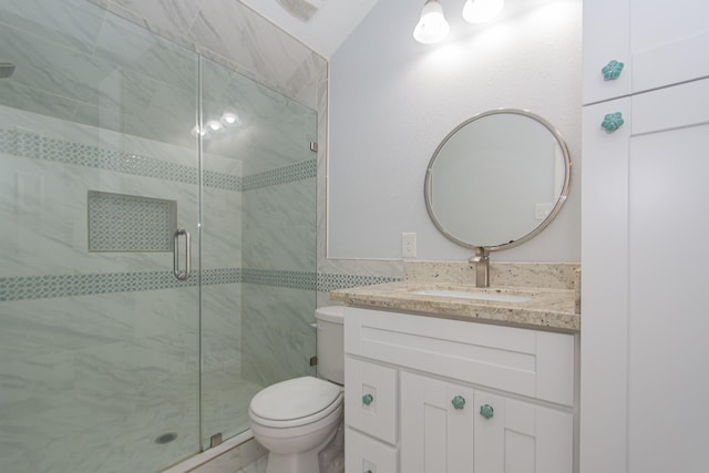 bathroom featuring vanity, toilet, and walk in shower