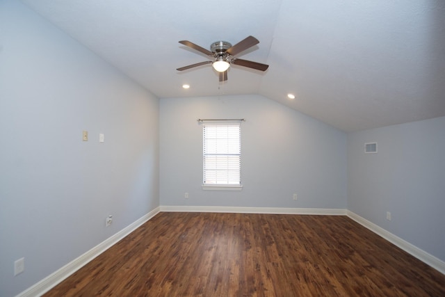 additional living space with dark hardwood / wood-style floors, ceiling fan, and vaulted ceiling