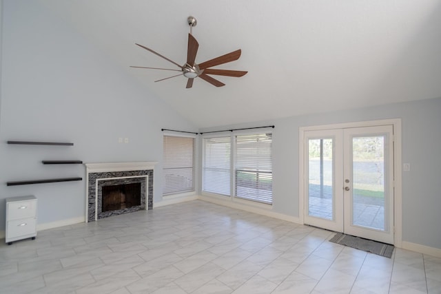 unfurnished living room featuring french doors, high vaulted ceiling, ceiling fan, and a premium fireplace