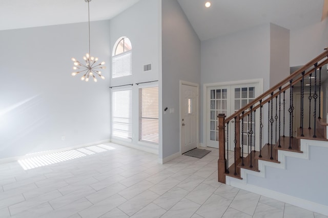 foyer featuring high vaulted ceiling and a chandelier