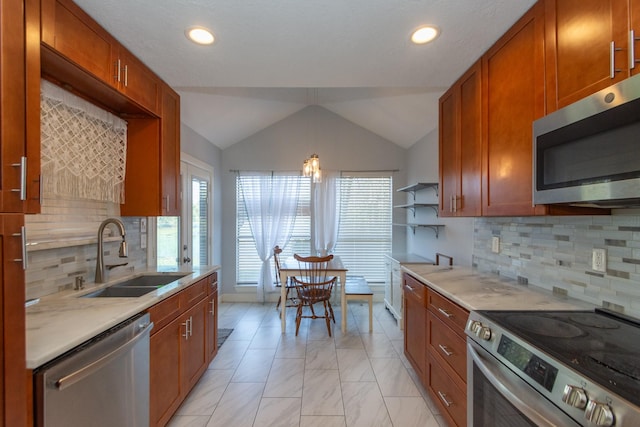 kitchen with backsplash, sink, stainless steel appliances, and lofted ceiling