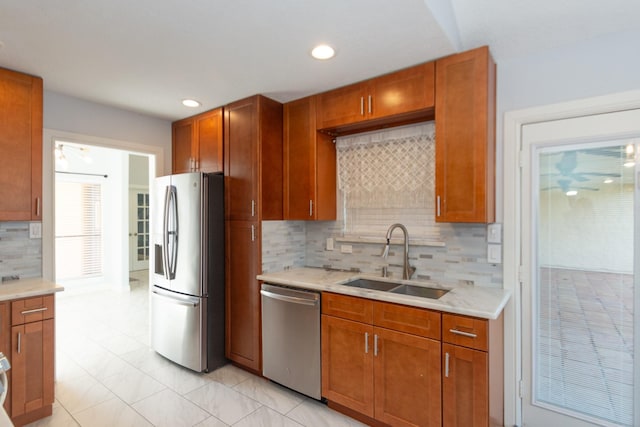 kitchen with decorative backsplash, stainless steel appliances, and sink