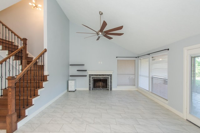 unfurnished living room featuring a fireplace, ceiling fan with notable chandelier, light tile patterned flooring, and lofted ceiling