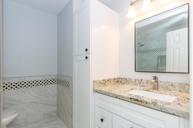 bathroom with vanity, toilet, and walk in shower