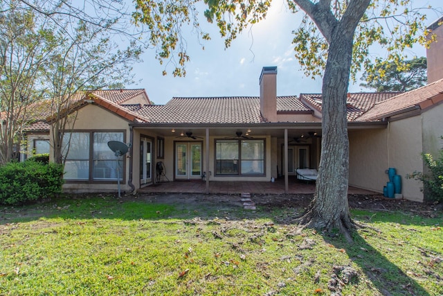 rear view of house with a yard, a patio area, ceiling fan, and french doors