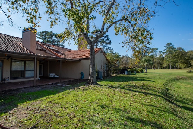 view of yard featuring central AC unit and a patio area