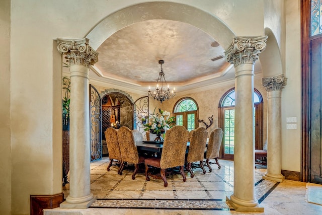 28322 Meadow Frst, Magnolia, TX 77355 - dining area with ornate columns, a raised ceiling, inlaid floor details, a chandelier, and crown molding
