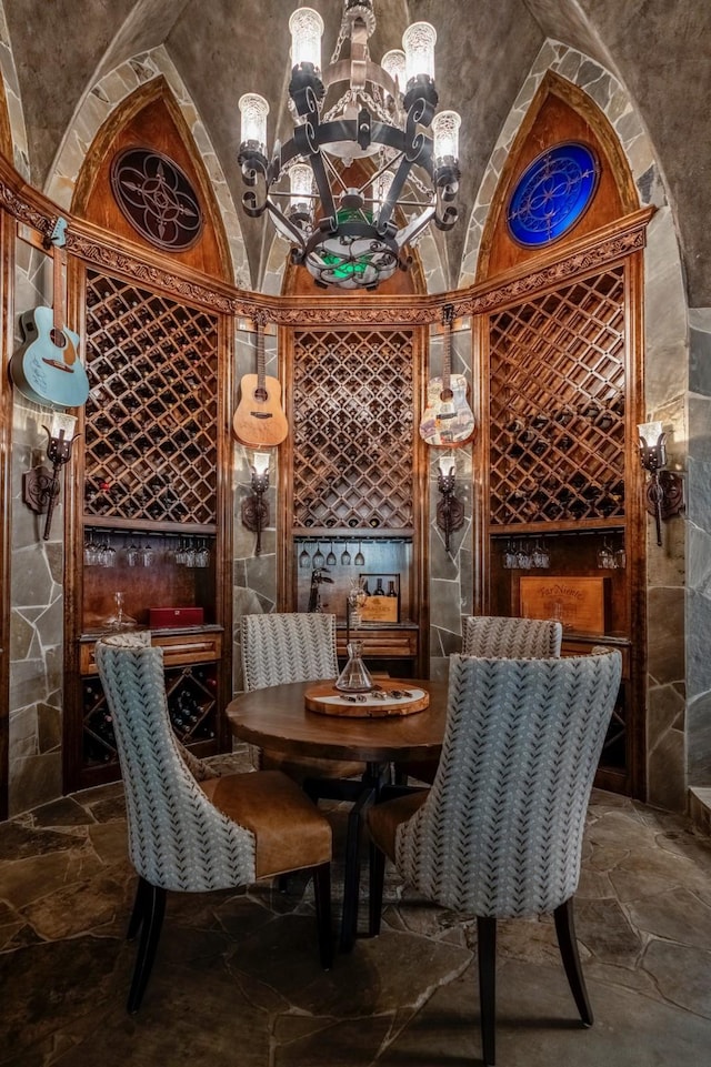 28322 Meadow Frst, Magnolia, TX 77355 - wine area featuring stone tile floors, a chandelier, and lofted ceiling