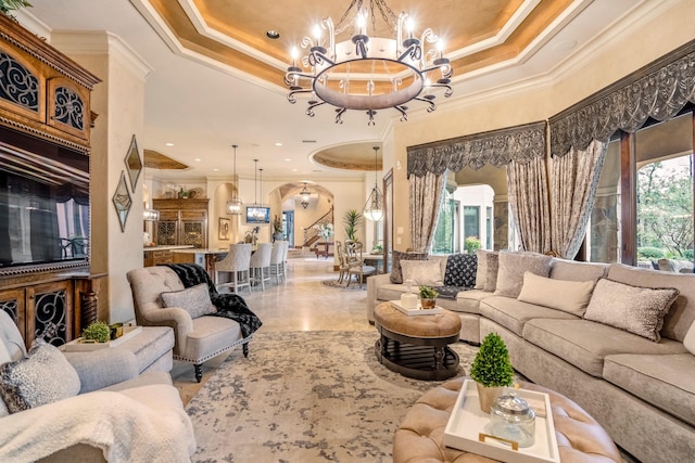 28322 Meadow Frst, Magnolia, TX 77355 - living room featuring ornamental molding, a chandelier, arched walkways, and a raised ceiling