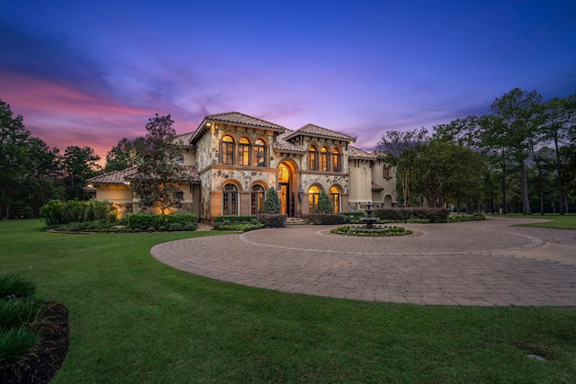 28322 Meadow Frst, Magnolia, TX 77355 - mediterranean / spanish-style home with stone siding, curved driveway, and a front yard