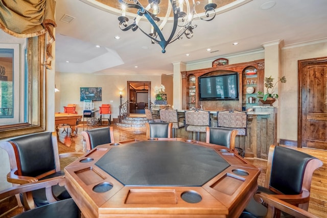 game room featuring crown molding, hardwood / wood-style floors, and a notable chandelier