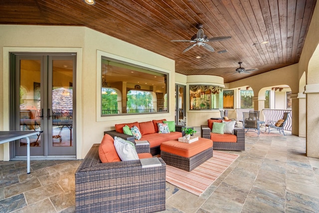 view of patio with an outdoor living space, french doors, and ceiling fan