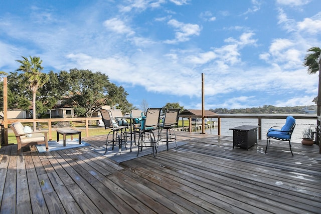 wooden deck featuring a water view