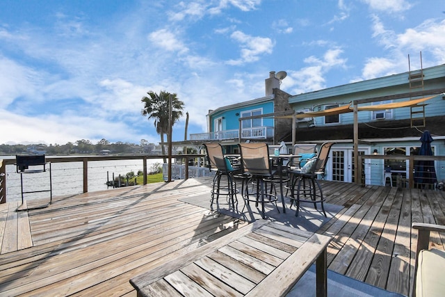 wooden deck featuring a water view