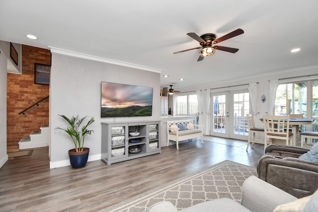 living room with french doors, brick wall, ornamental molding, and hardwood / wood-style flooring