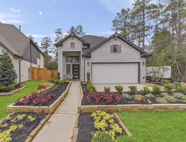 view of front of house featuring a garage and a front lawn