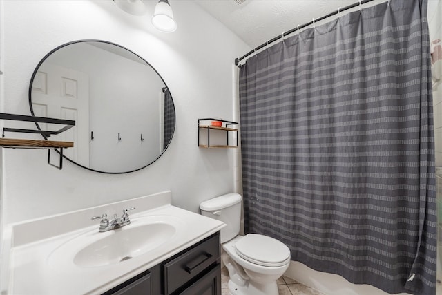 bathroom featuring vanity, tile patterned flooring, toilet, a textured ceiling, and curtained shower